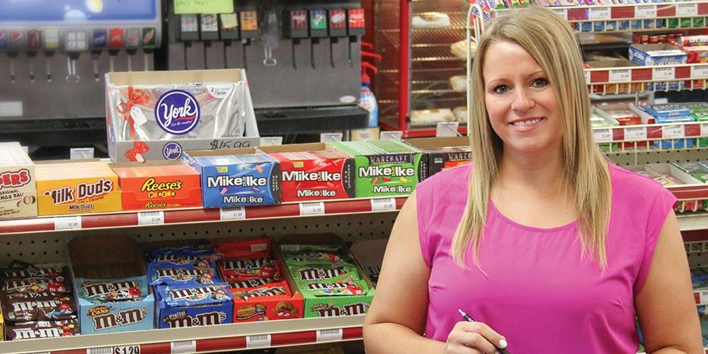 woman standing in candy aisle in a convenience store